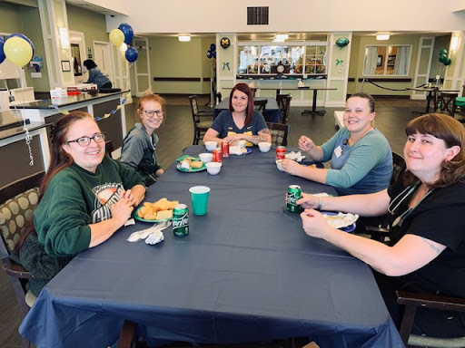 A cheerful gathering of friends enjoying a meal together.