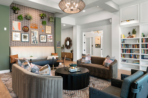A contemporary living room featuring stylish furniture, decorative artwork, and a warm, inviting ambiance.