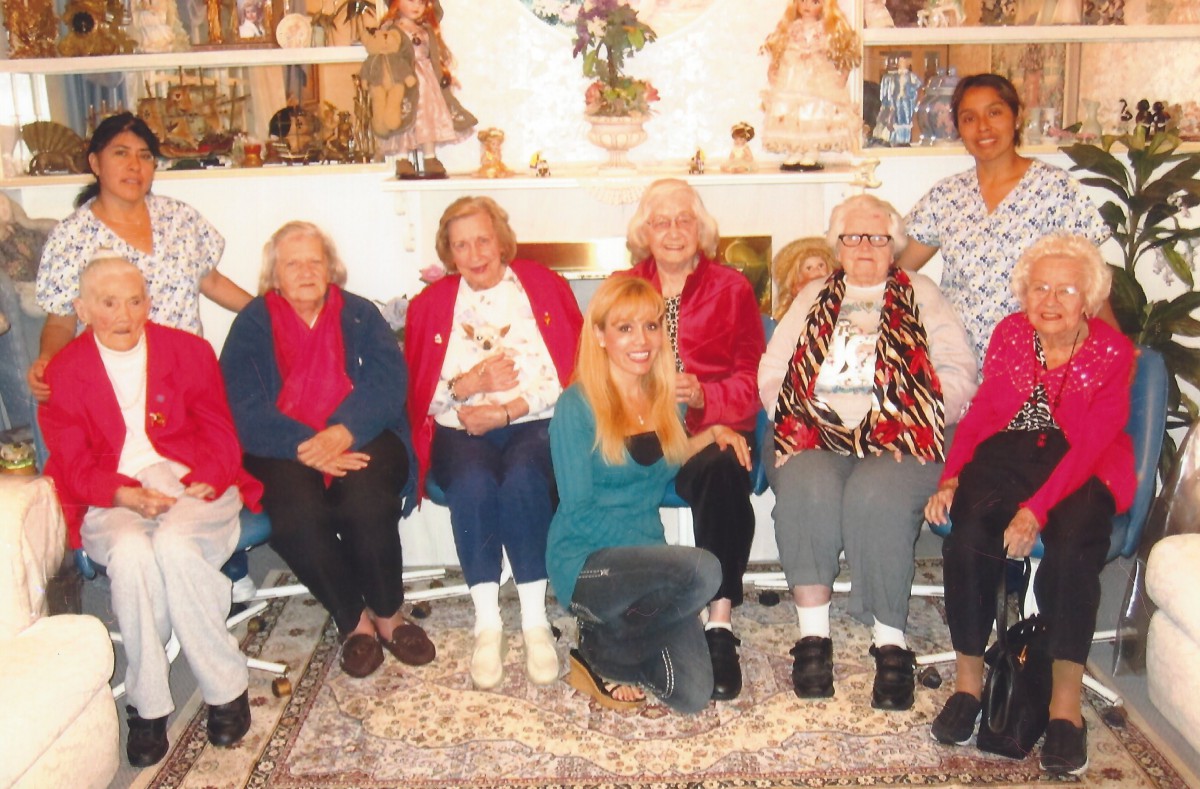 A group of seniors gathered together indoors, posing for a photo.