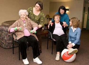 A group of seniors engaged in a fun and supportive exercise session, promoting health and well-being.