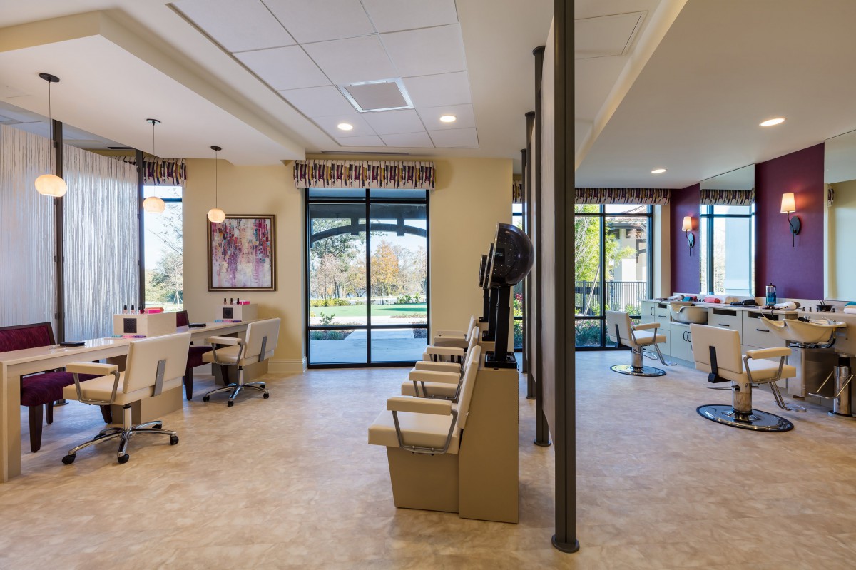 A modern office reception area with natural lighting and stylish furnishings.