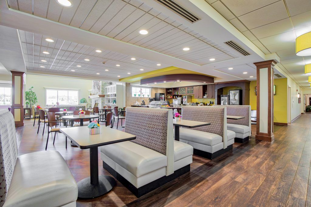 A modern restaurant interior featuring booth seating and ambient lighting.