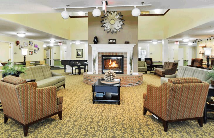 A cozy living room with a fireplace and comfortable seating.