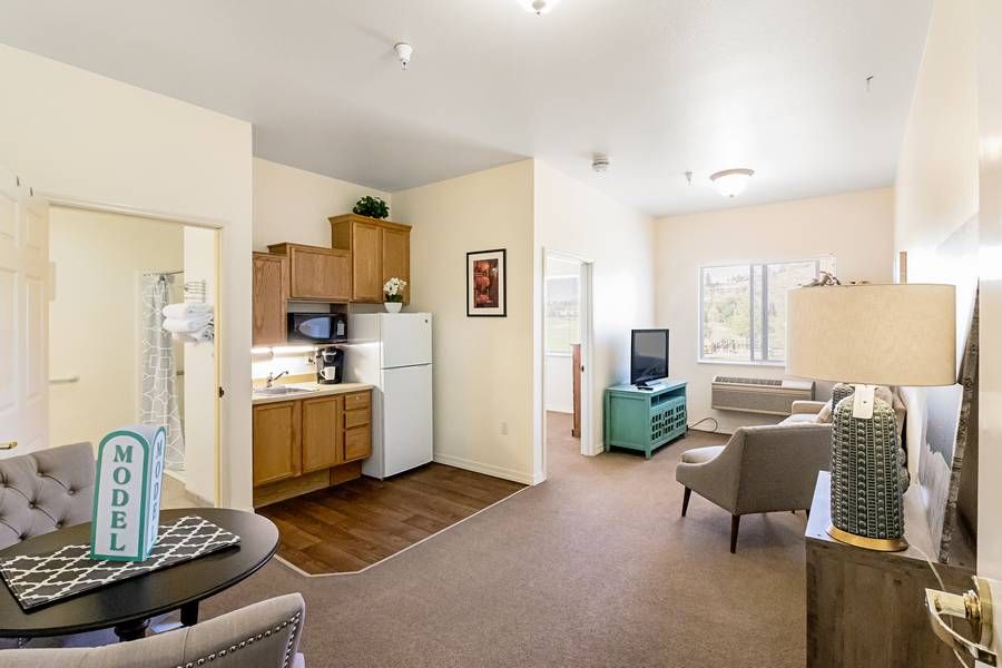 A cozy apartment with a modern living room and compact kitchen area.