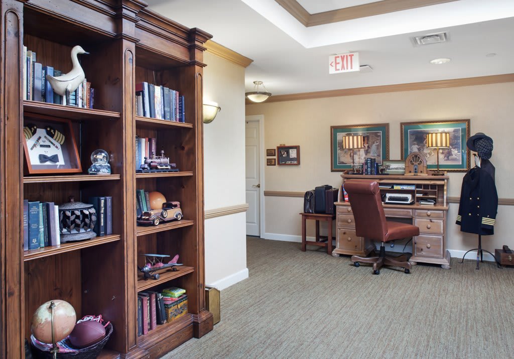 A well-organized office space featuring a bookshelf and a desk.