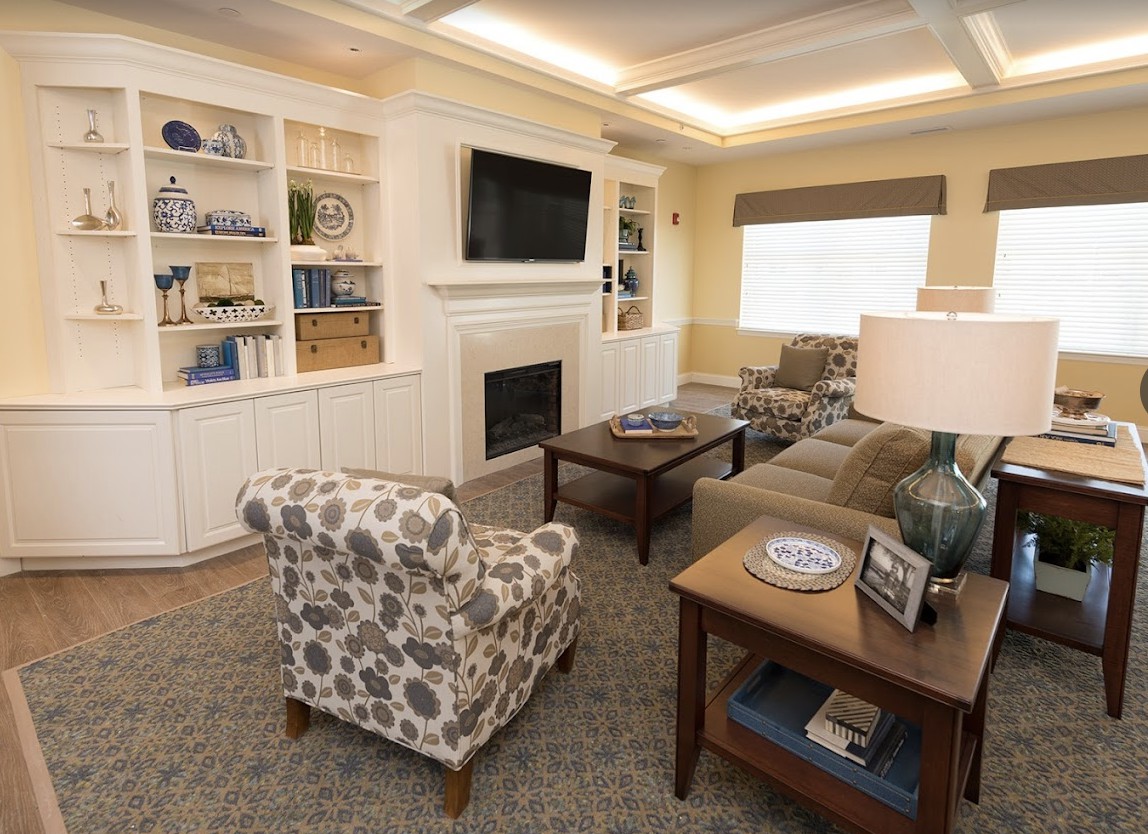 A cozy living room with a fireplace, TV, and stylish furniture.