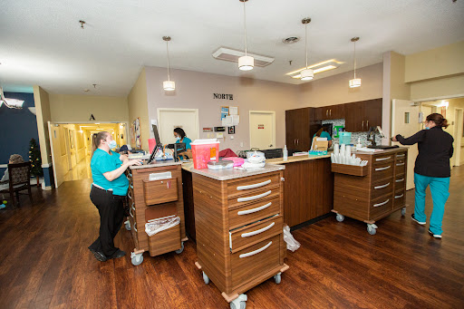 A view of a busy medical office reception area with staff attending to tasks.