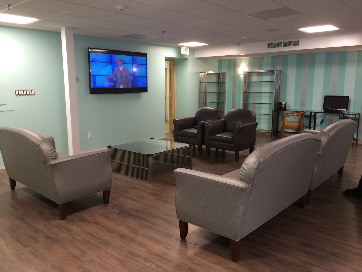 A cozy lounge area with comfortable seating and a wall-mounted television.