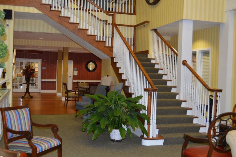 A welcoming lobby area with a staircase and comfortable seating.