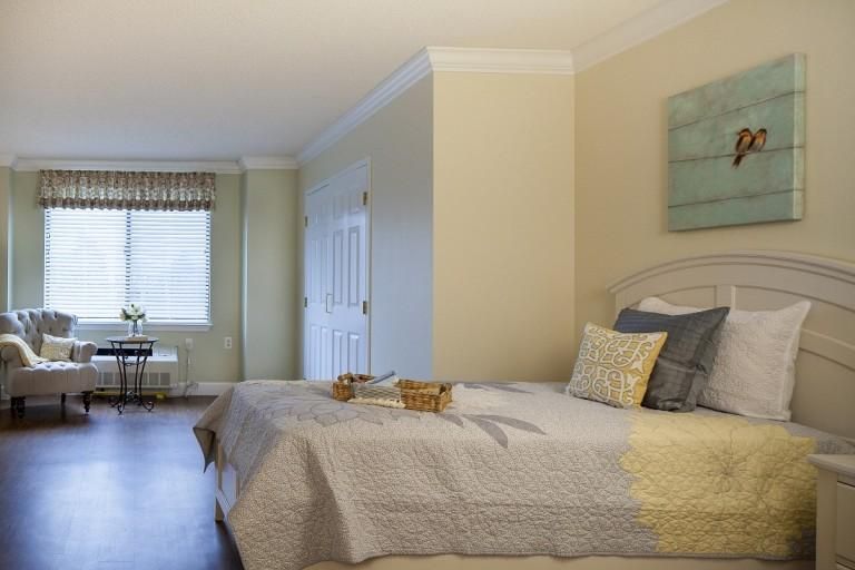 A cozy bedroom with soft colors and ample natural light.