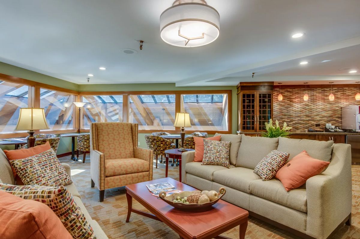 A cozy and elegantly decorated living room with comfortable seating and warm lighting.