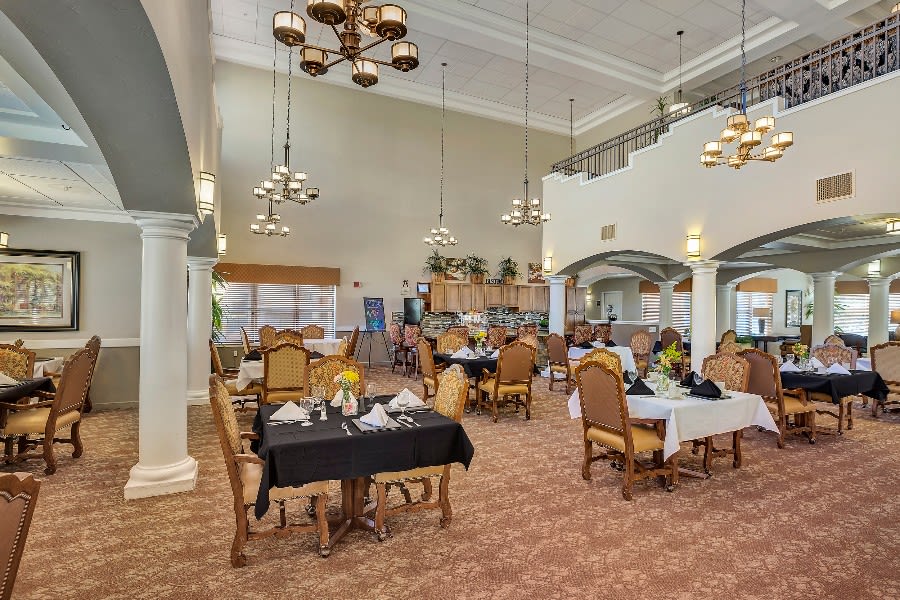 A spacious dining room with elegant decor and neatly arranged tables and chairs.