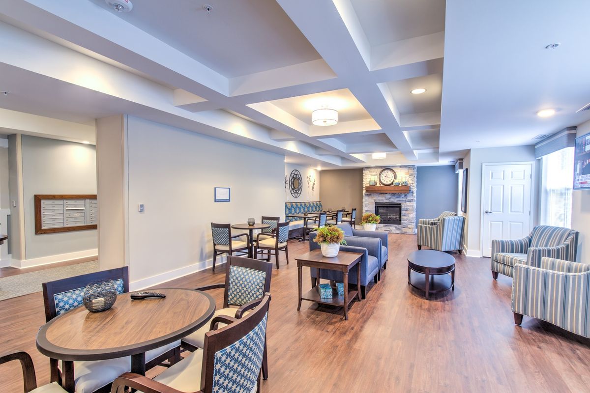 A spacious and modern living area featuring comfortable seating, a fireplace, and stylish decor.
