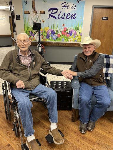 Two friends sharing a moment together in an assisted living facility.