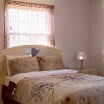 Cozy bedroom with a neatly made bed and soft lighting.