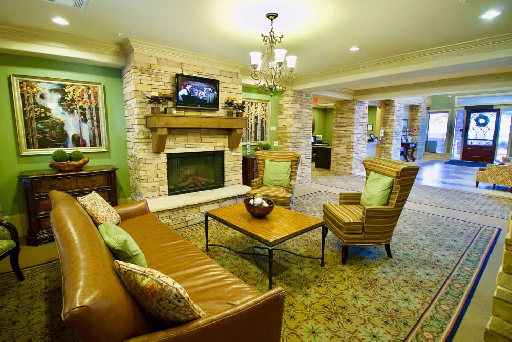 A cozy living room featuring a fireplace, comfortable seating, and a warm ambiance.