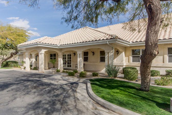 A single-story house with a tiled roof and well-maintained landscaping.
