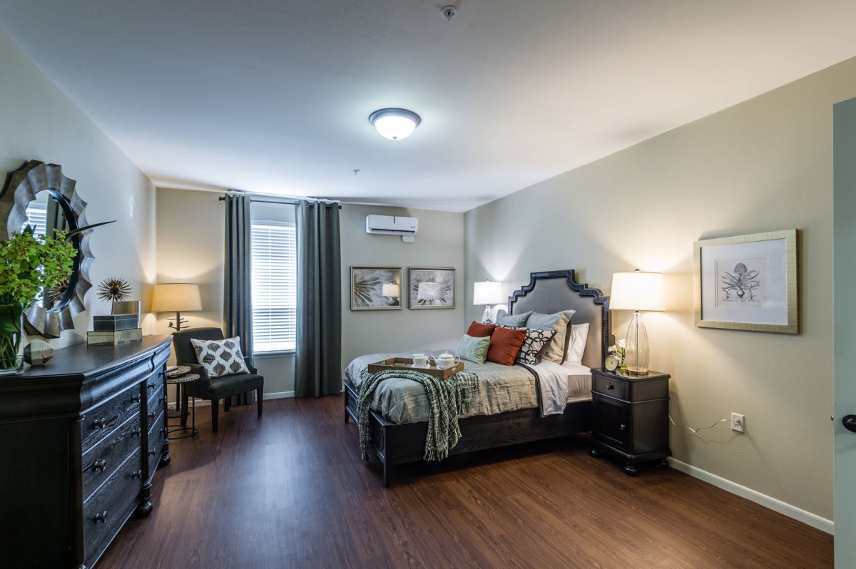 A modern and comfortable bedroom with stylish decor and ample natural lighting.