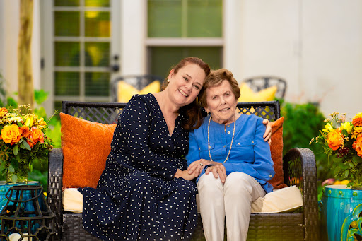 A heartwarming moment shared between two women, enjoying each other's company in a cozy outdoor setting.