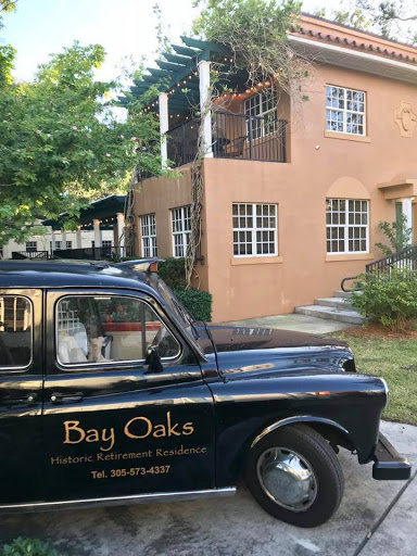 A classic taxi in front of a charming building, showcasing local character.