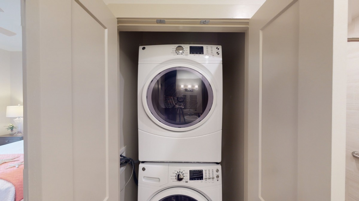 Stacked washer and dryer in a compact laundry closet.