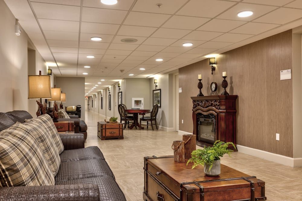 A cozy and elegant lobby with comfortable seating and a decorative fireplace.