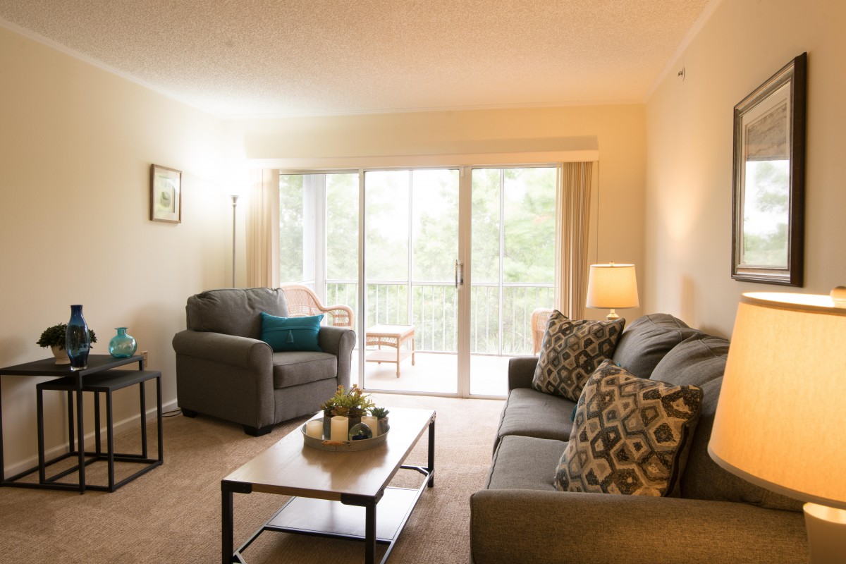 A cozy living room with comfortable seating and natural lighting.