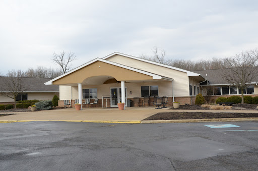 A welcoming residential building with a shaded entryway and landscaped surroundings.