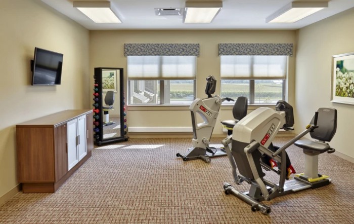 A small indoor fitness room with stationary bikes and exercise equipment.