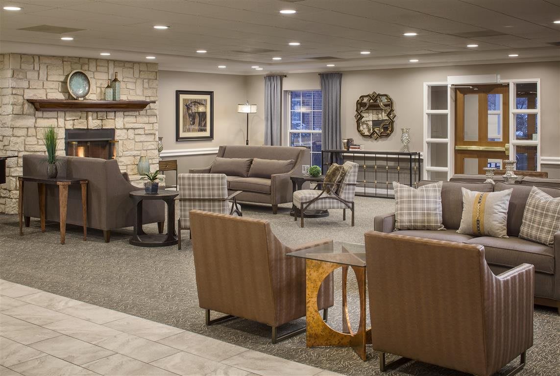 A cozy and well-furnished living room with sofas, chairs, and stylish decor.
