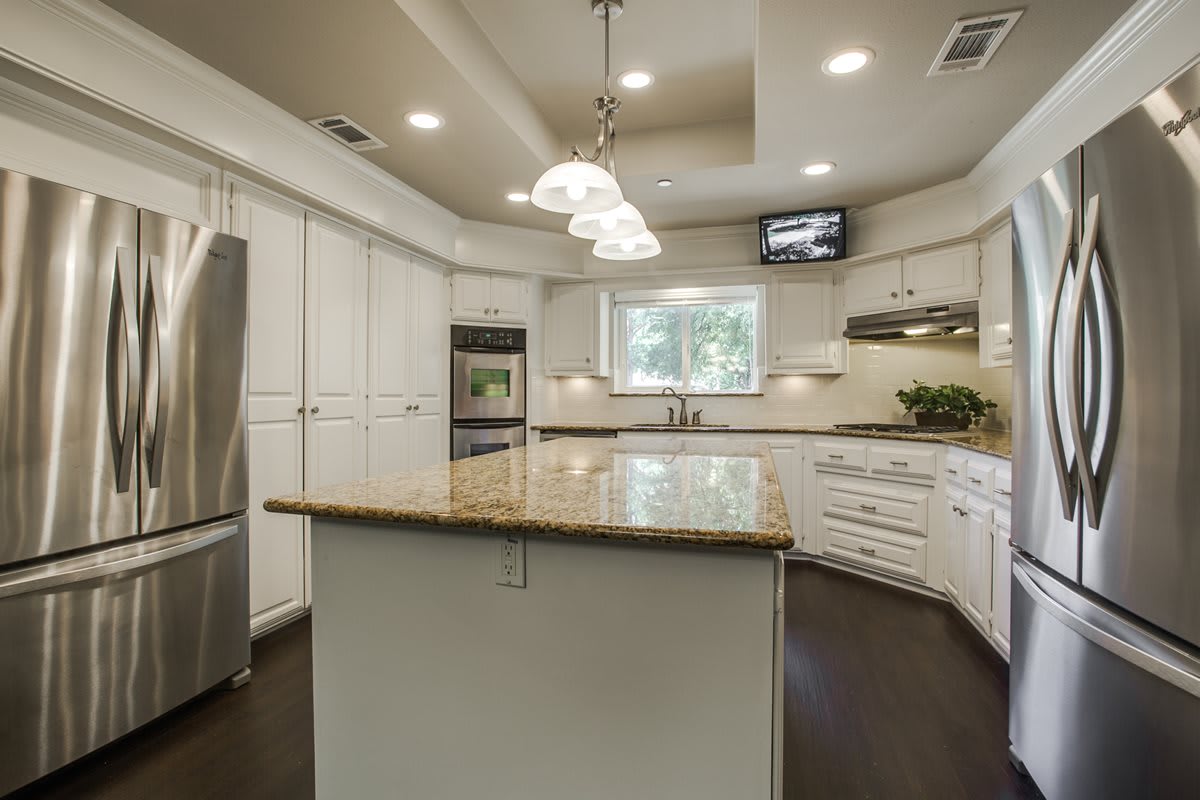 Modern kitchen with an island counter and white cabinetry.
