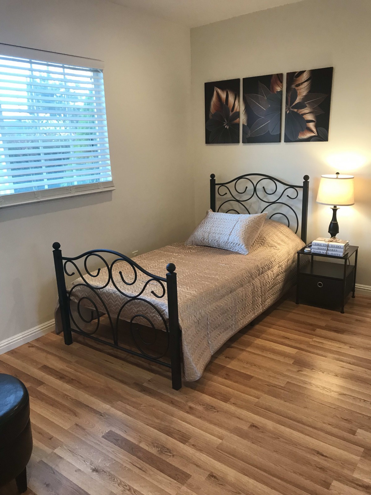 A cozy bedroom with a single bed and decorative elements.