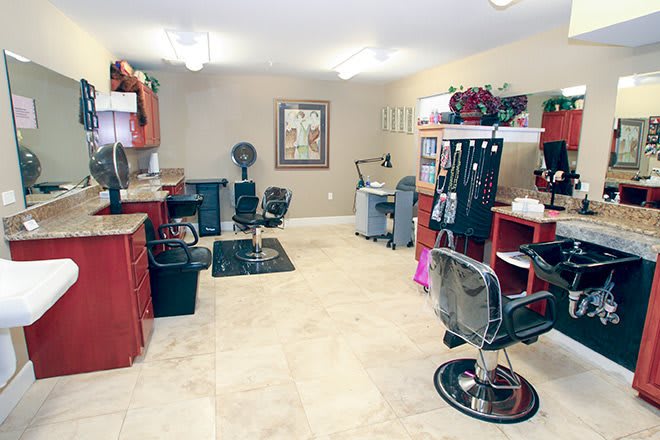 A well-equipped and organized hair salon interior with multiple styling stations.