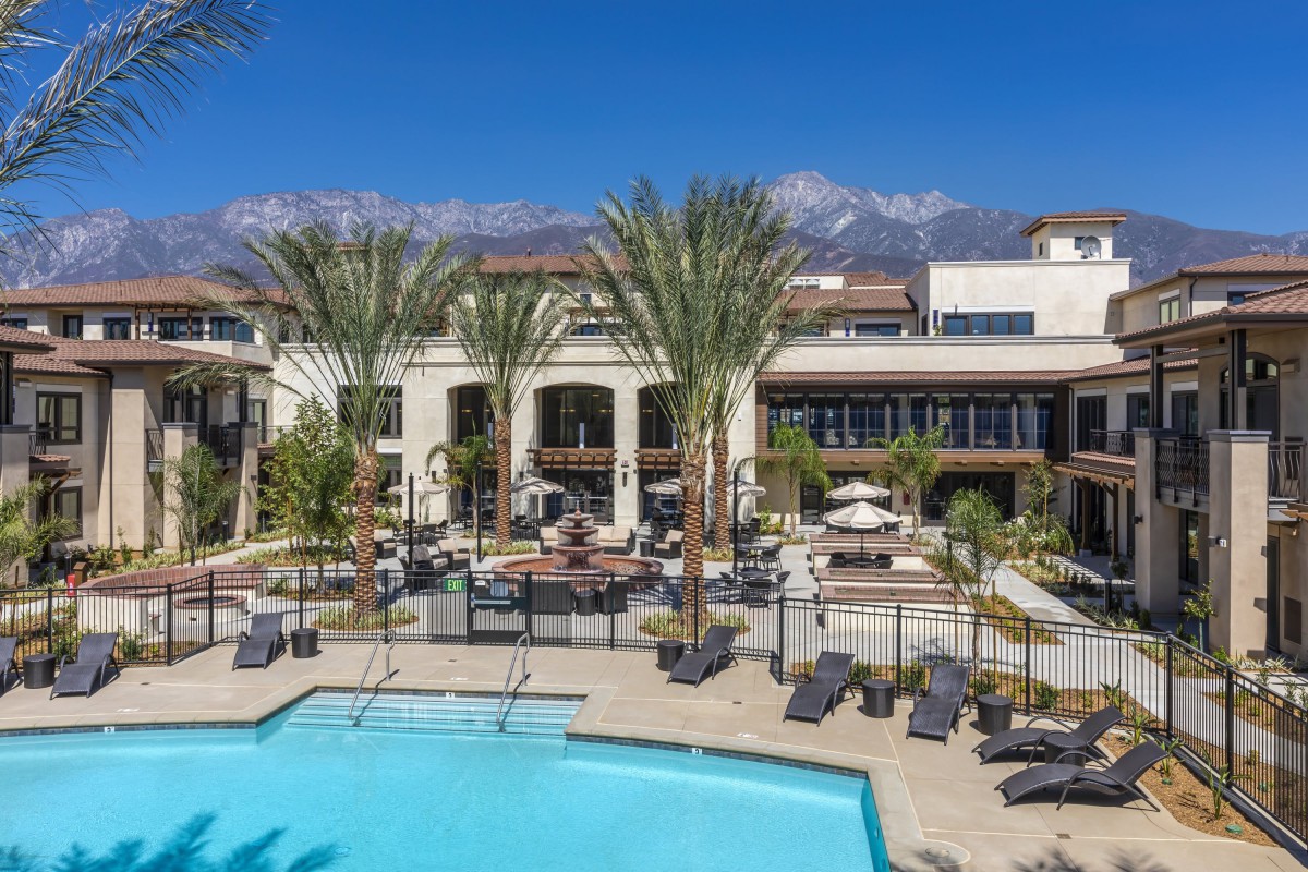 A luxurious hotel with a stunning pool area and scenic mountain views.