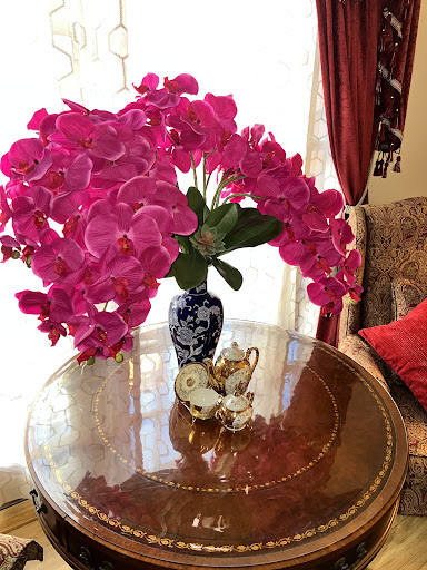 A vibrant display of pink orchids in a decorative vase, adding elegance to the living space.