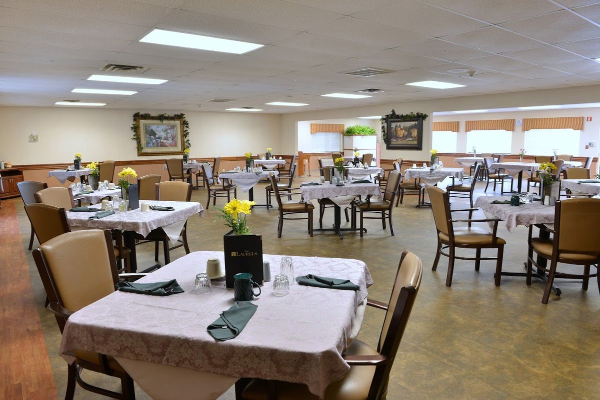 An elegantly set dining area with neatly arranged tables and chairs, ready for guests.
