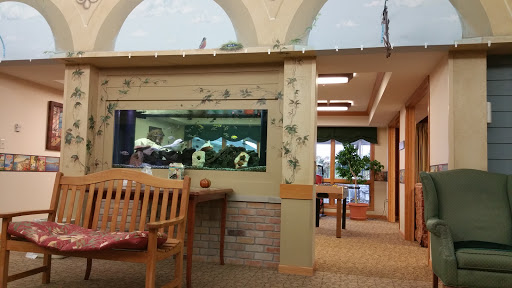 A cozy waiting area featuring an aquarium and comfortable seating.