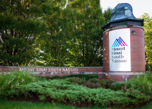 Welcome sign for Mount Sinai South Nassau, surrounded by greenery.