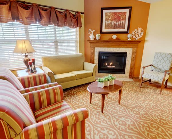 Cozy living room with a fireplace and colorful furnishings.