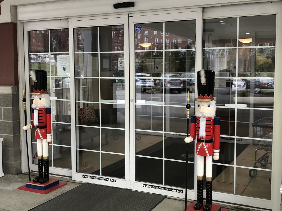 Nutcracker figures standing guard at the entrance of a store.