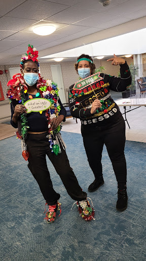 Two friends celebrating the holiday season in colorful outfits and masks, bringing joy and festive spirit.
