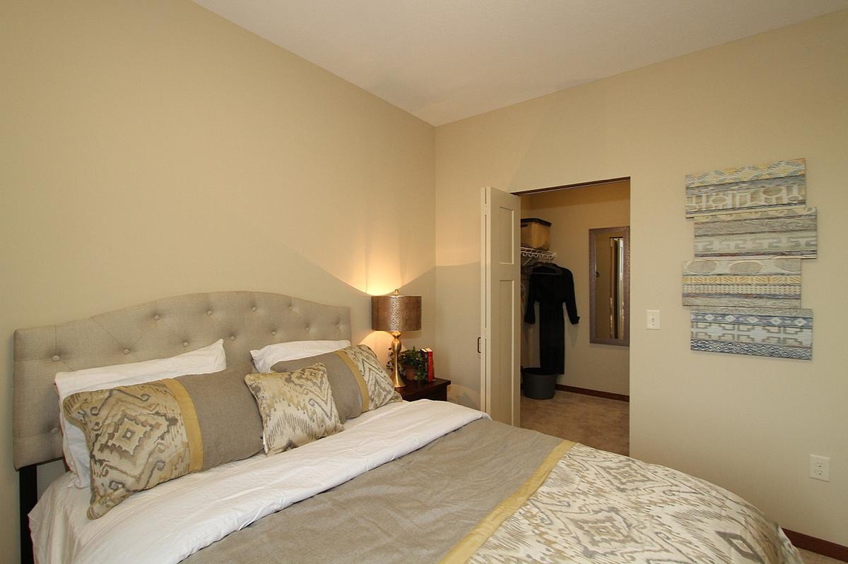 A cozy and well-decorated bedroom with soft lighting and comfortable bedding.