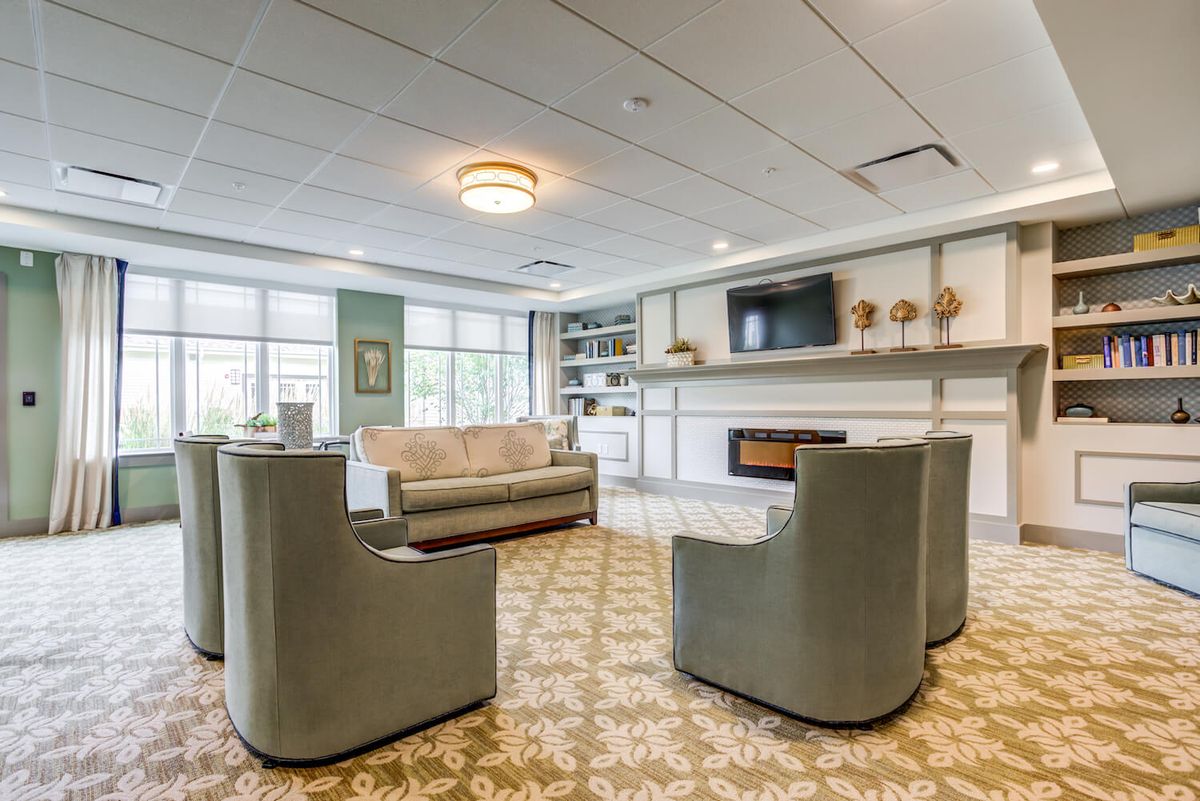 A modern living room with comfortable seating, a television, and a fireplace.