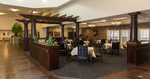 An elegant dining area with neatly arranged tables and chairs, accentuated by warm lighting and decor.