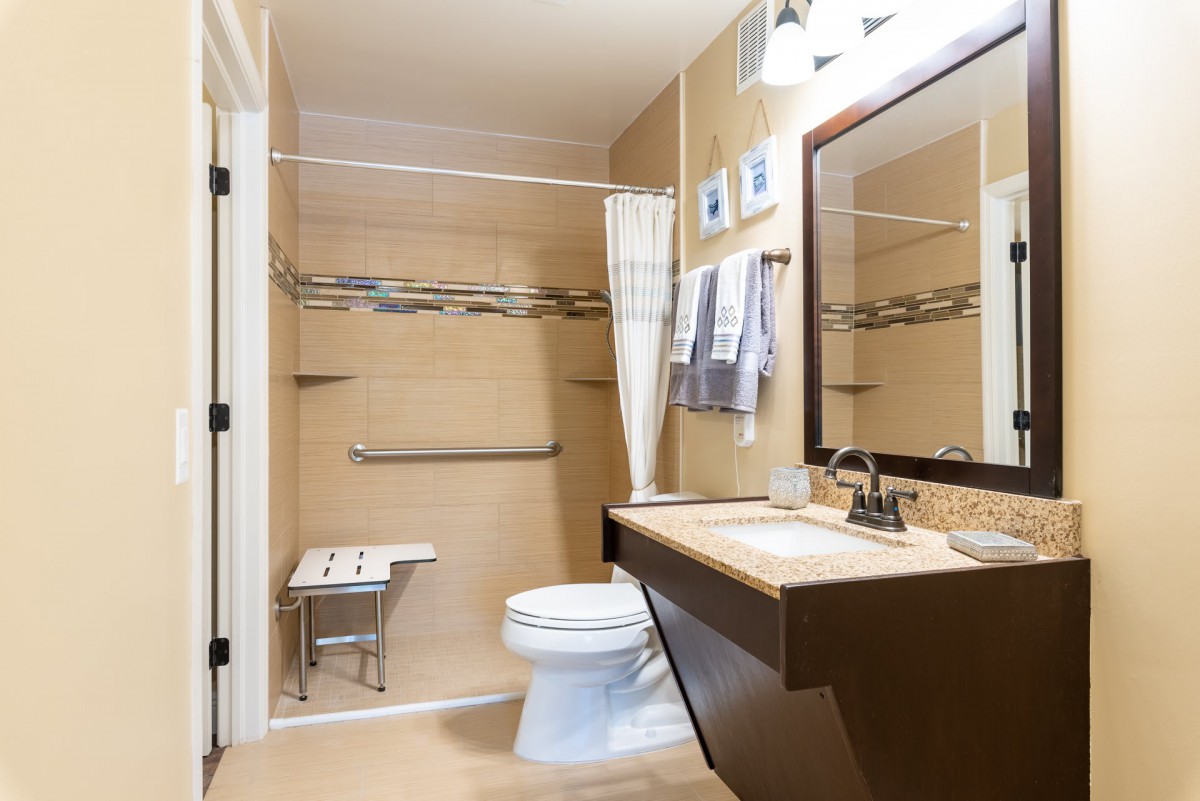 Modern bathroom with a shower, toilet, and sink.