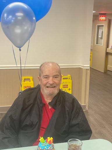 A cheerful man enjoying a celebration with balloons.