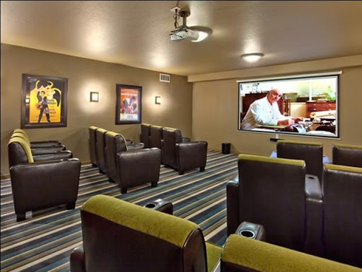 A cozy home theater setup with comfortable recliners and a large screen for movie viewing.