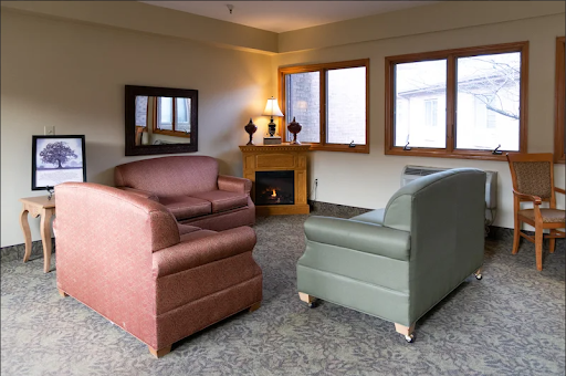A cozy living room setup featuring two armchairs and warm lighting.
