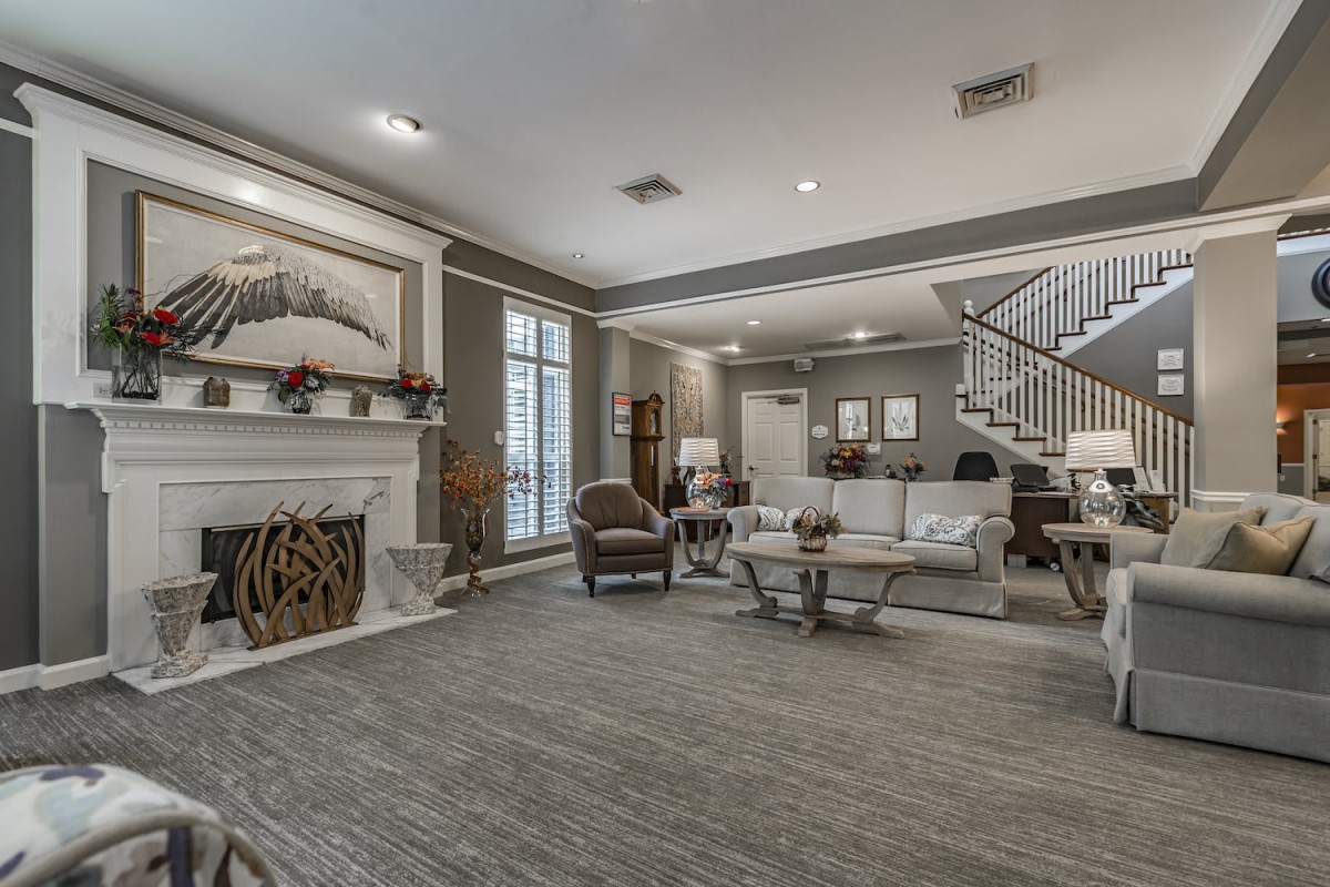 A modern living room featuring a cozy fireplace, comfortable seating, and stylish decor.