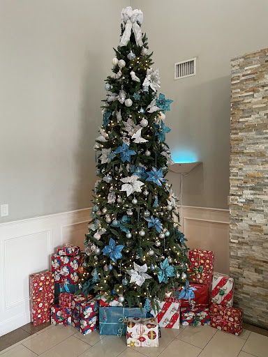 A beautifully decorated Christmas tree surrounded by colorful presents.
